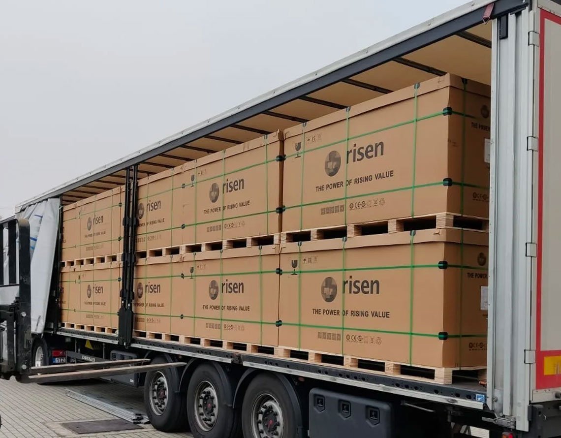 Risen solar module cartons stacked on pallets inside a delivery truck Risen solar module cartons stacked on pallets inside a delivery truck